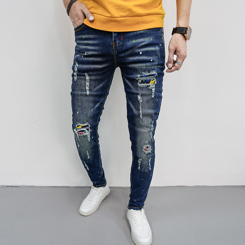 Herren Skinny Fit Jeans mit kreativen Farbklecksen und Rissdesign Stalluxe