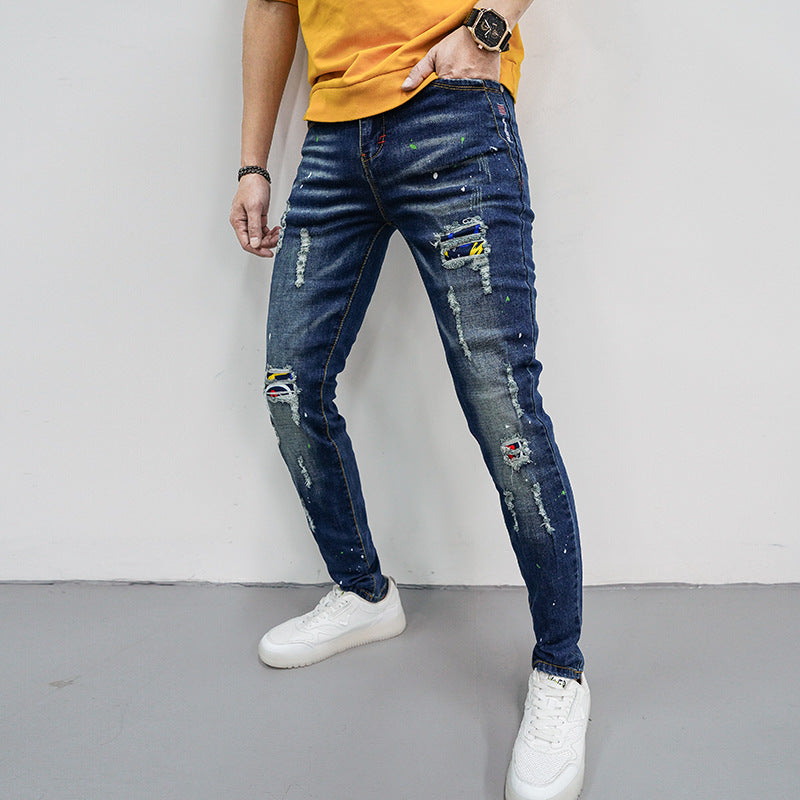 Herren Skinny Fit Jeans mit kreativen Farbklecksen und Rissdesign Stalluxe