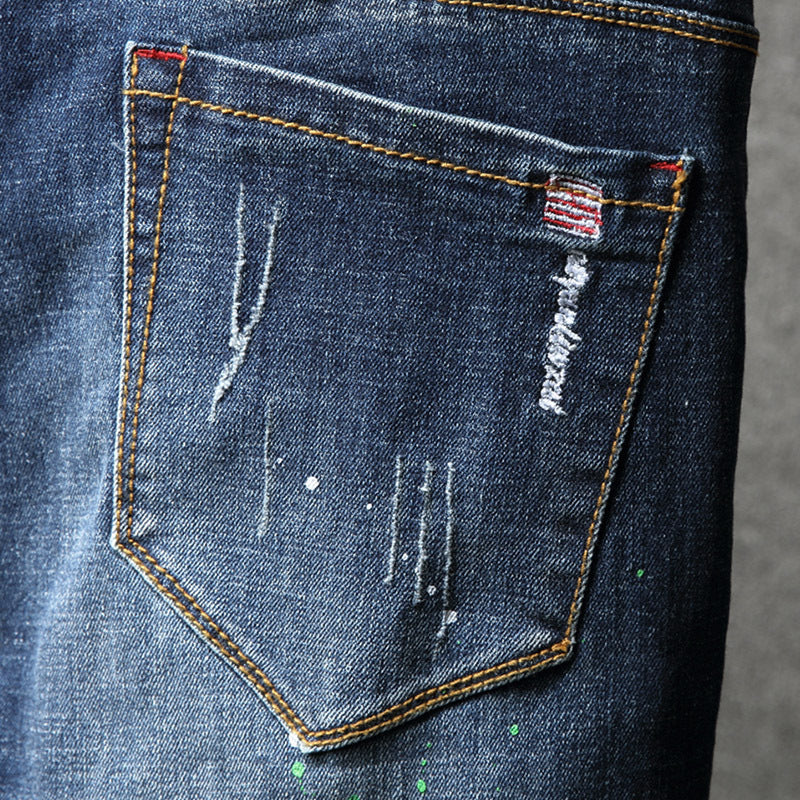Herren Ripped Slim Fit Jeans mit kreativen Farbklecksen und modischem Destroyed-Look Stalluxe