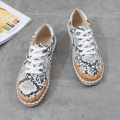 Damen Sneaker mit korkähnlicher Sohle und stylischem Schlangenmotiv Stalluxe