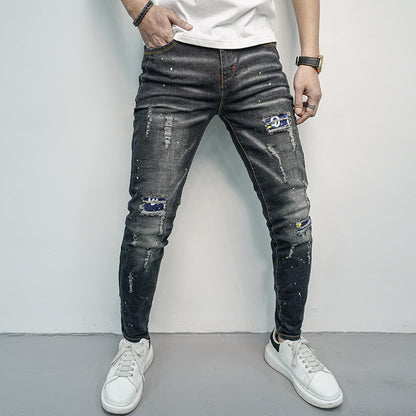 Herren Skinny Fit Jeans im kreativen Rissdesign und bunten Farbsklecks Stalluxe