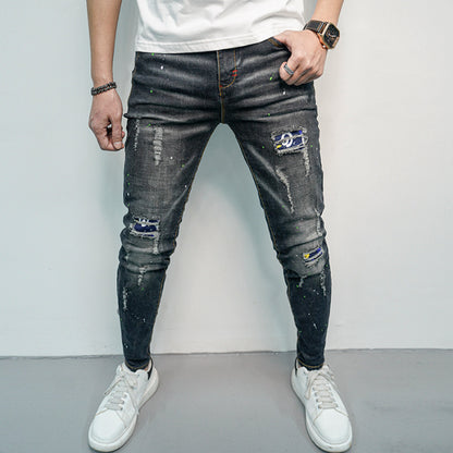 Herren Skinny Fit Jeans im kreativen Rissdesign und bunten Farbsklecks Stalluxe