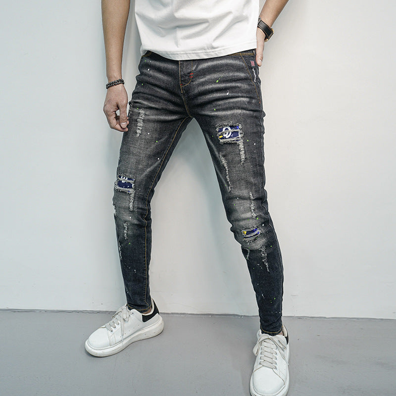 Herren Skinny Fit Jeans im kreativen Rissdesign und bunten Farbsklecks Stalluxe