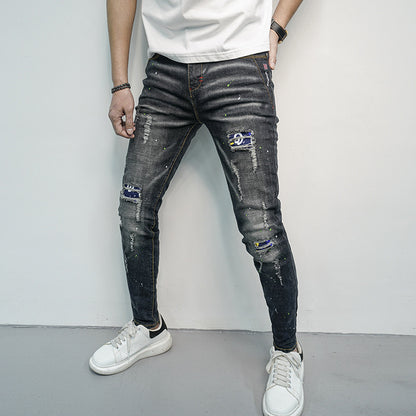 Herren Skinny Fit Jeans im kreativen Rissdesign und bunten Farbsklecks Stalluxe