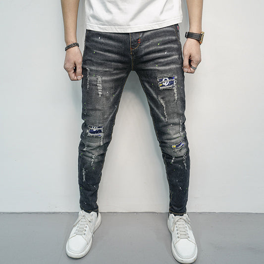 Herren Skinny Fit Jeans im kreativen Rissdesign und bunten Farbsklecks Stalluxe