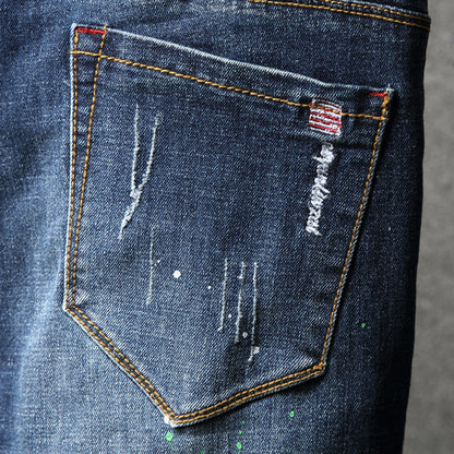 Herren Ripped Slim Fit Jeans mit kreativen Farbklecksen und modischem Destroyed-Look Stalluxe