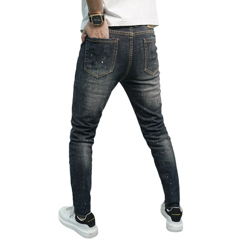 Herren Skinny Fit Jeans im kreativen Rissdesign und bunten Farbsklecks Stalluxe